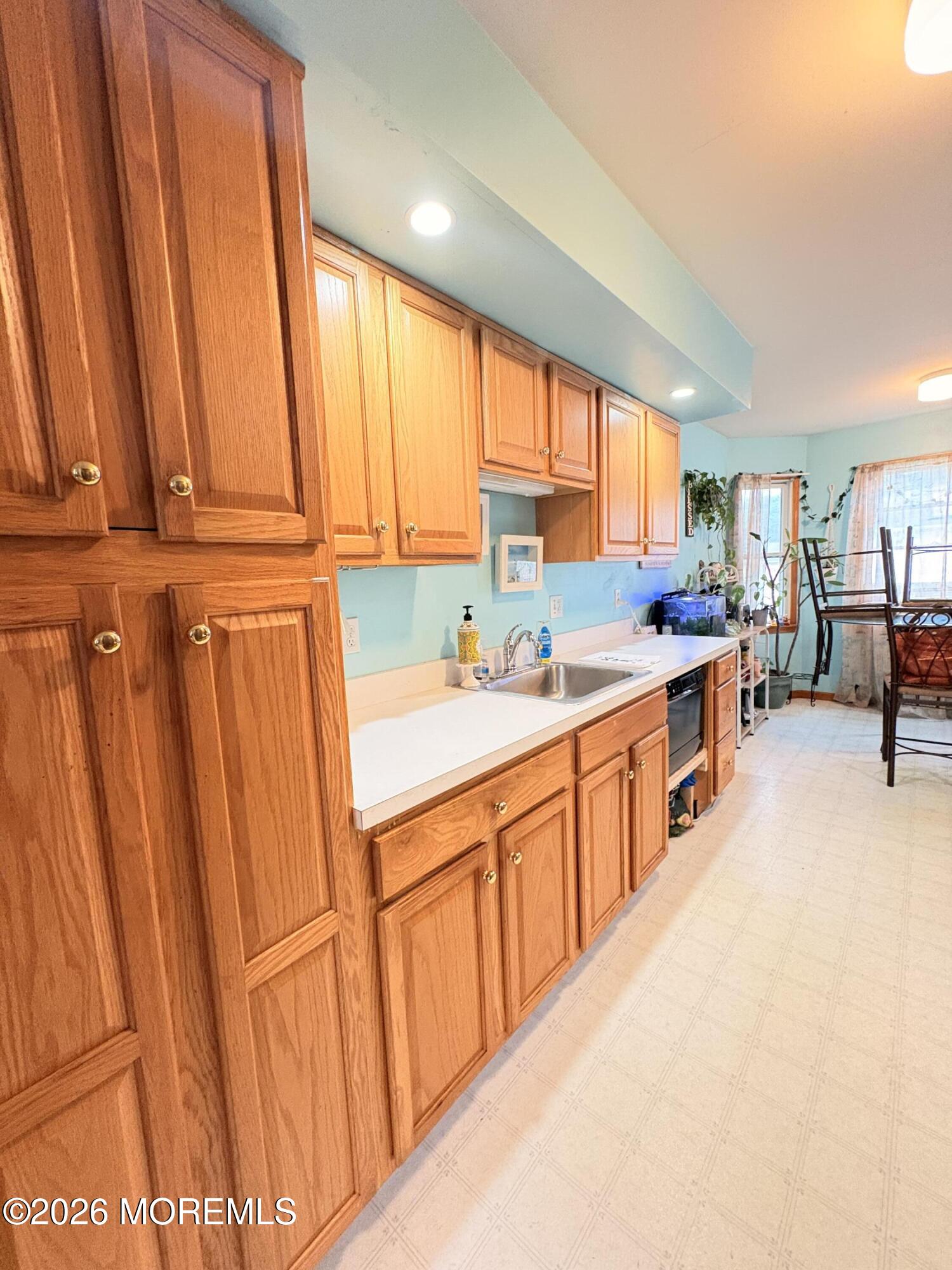 456 Dock Road Forked River, NJ 08731 - Photo 7 of 14 a kitchen with stainless steel appliances a sink and cabinets