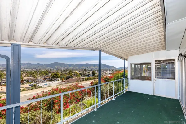 a view of a city from a balcony with furniture