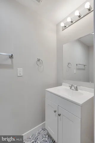 a bathroom with a sink vanity and a mirror