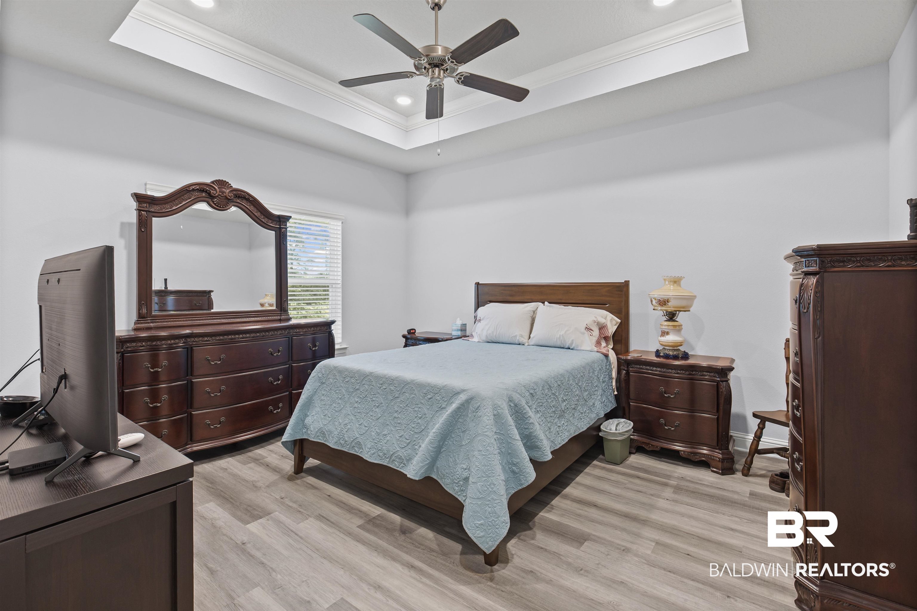 10564 Heirloom Road South Mobile, AL 36608 - Photo 13 of 24 Bedroom featuring a raised ceiling, crown molding, recessed lighting, light wood finished floors, and ceiling fan