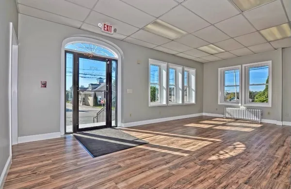a view of a livingroom with wooden floor and door