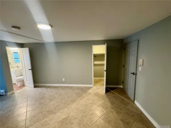 an empty room with an entrance to other room