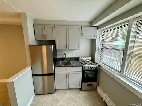 a kitchen with a stove a refrigerator and a sink