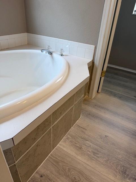 2321 Ridgeview Street Fort Worth, TX 76119 - Photo 9 of 10 Built-in soaking tub with white subway tile surround and coordinating white countertop