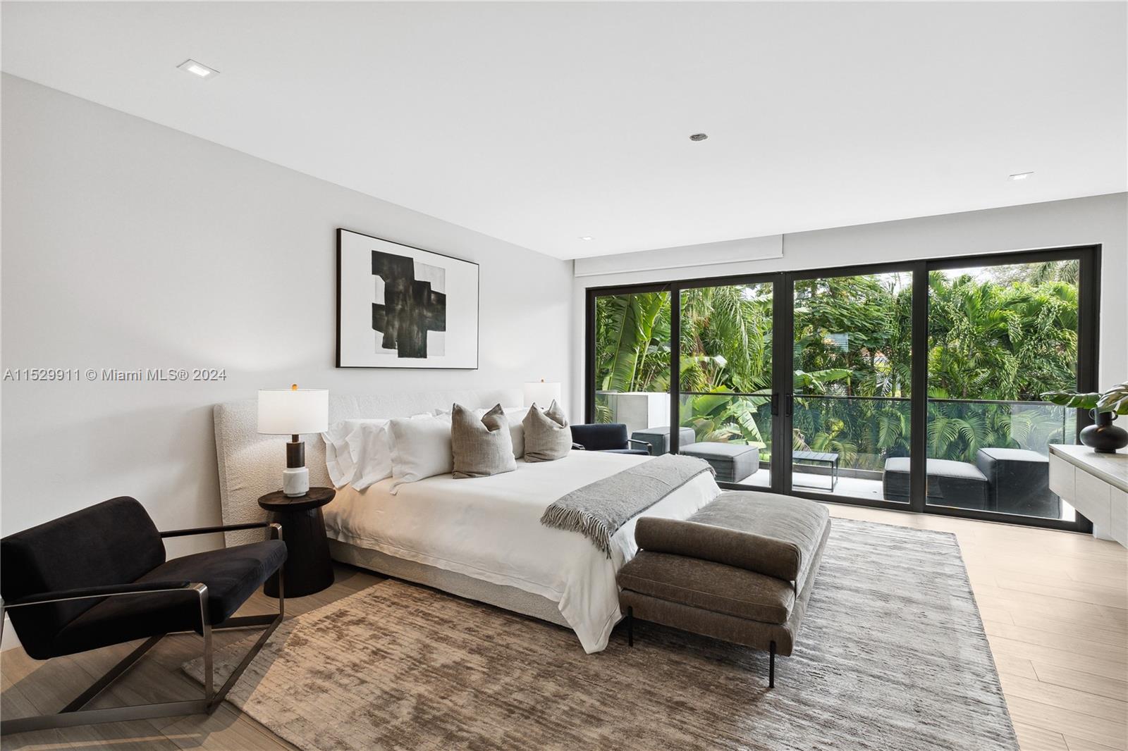 4060 Woodridge Road Miami, FL 33133 - Photo 12 of 49 a bedroom with a bed and a large window