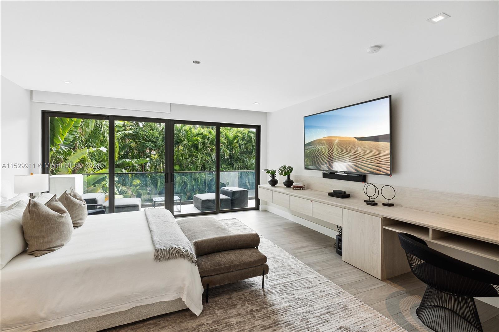 4060 Woodridge Road Miami, FL 33133 - Photo 14 of 49 a large bedroom with a bed and large windows