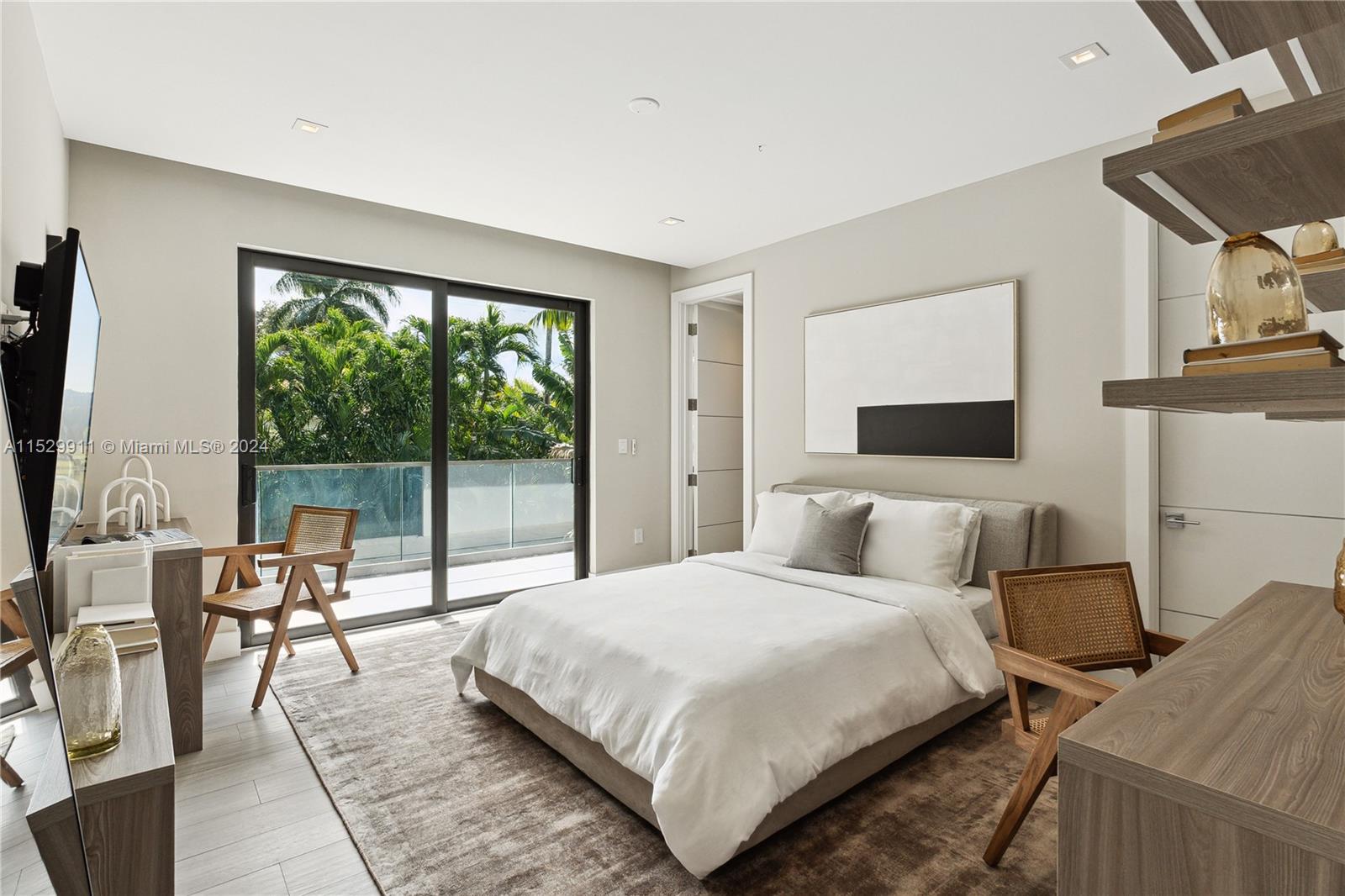 4060 Woodridge Road Miami, FL 33133 - Photo 19 of 49 a bedroom with a large bed and a large window