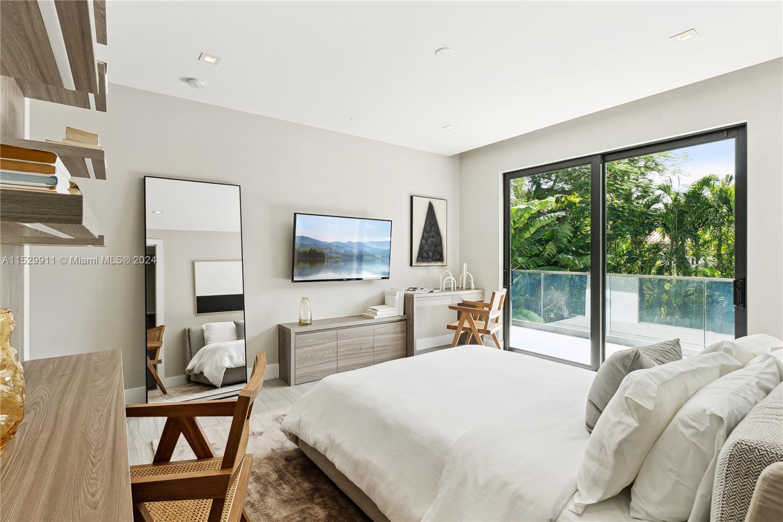 4060 Woodridge Road Miami, FL 33133 - Photo 20 of 49 a bedroom with a large window and a flat screen tv