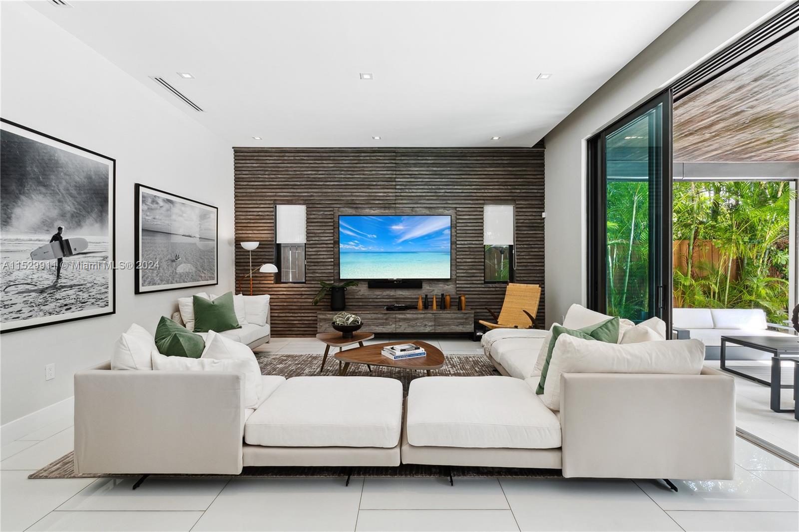 4060 Woodridge Road Miami, FL 33133 - Photo 2 of 49 a living room with furniture a large window and a flat screen tv