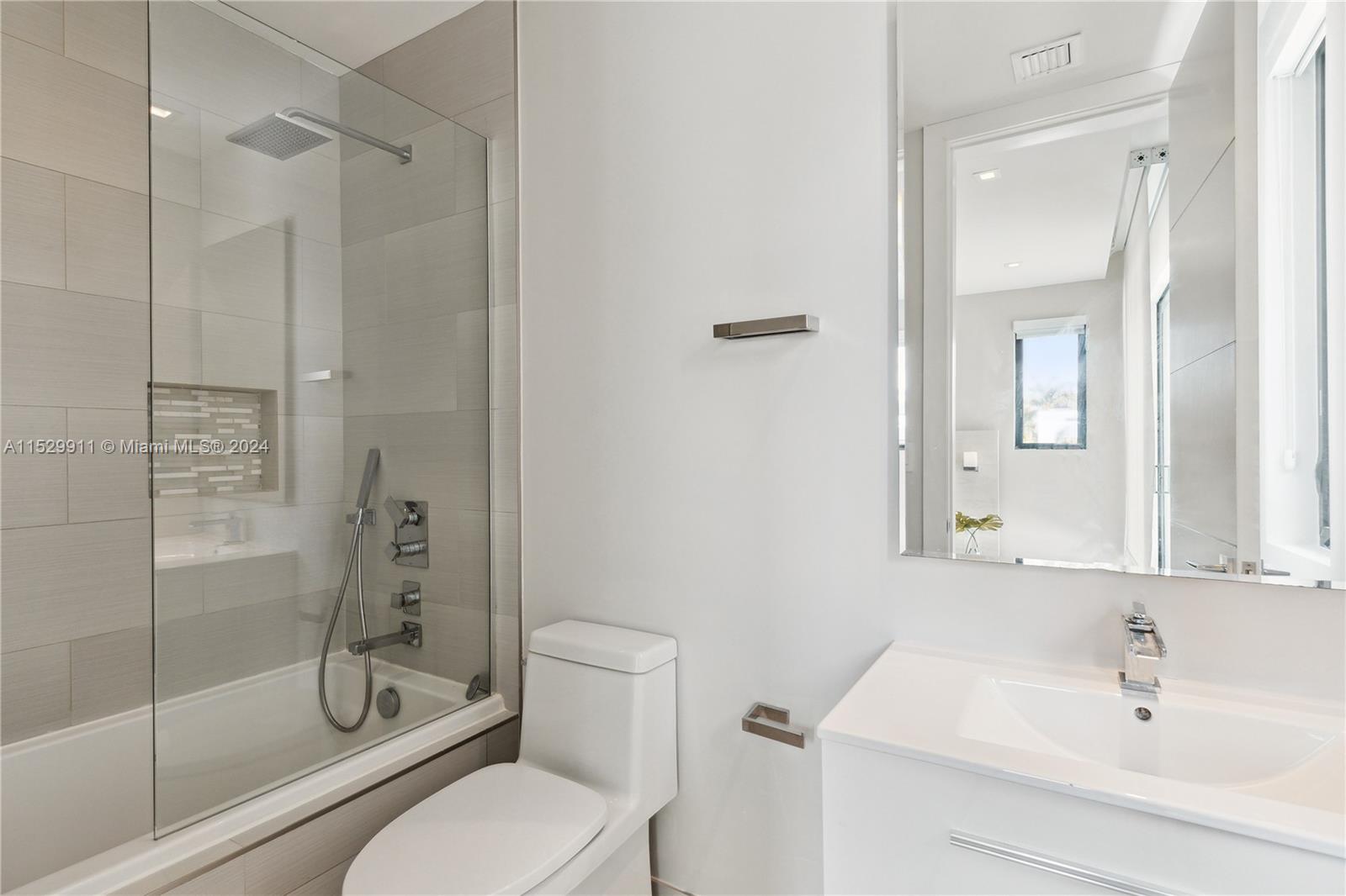 4060 Woodridge Road Miami, FL 33133 - Photo 23 of 49 a bathroom with a shower a toilet and a sink