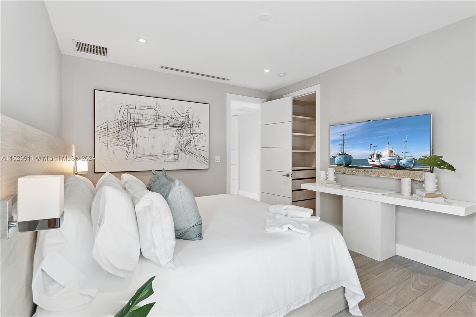 4060 Woodridge Road Miami, FL 33133 - Photo 24 of 49 a bedroom with a large bed and a kitchen view