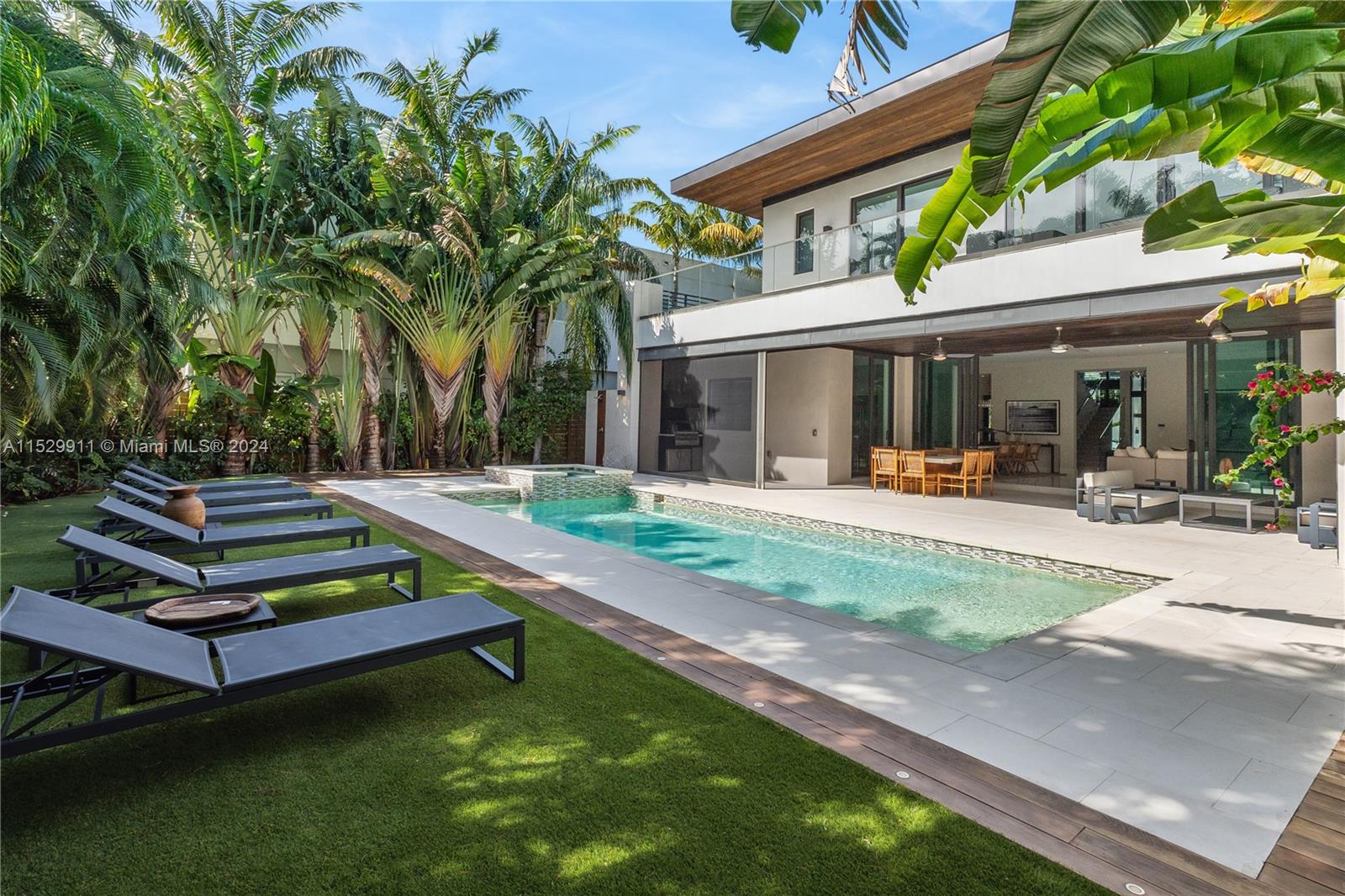 4060 Woodridge Road Miami, FL 33133 - Photo 3 of 49 a view of a house with backyard swimming pool and sitting area