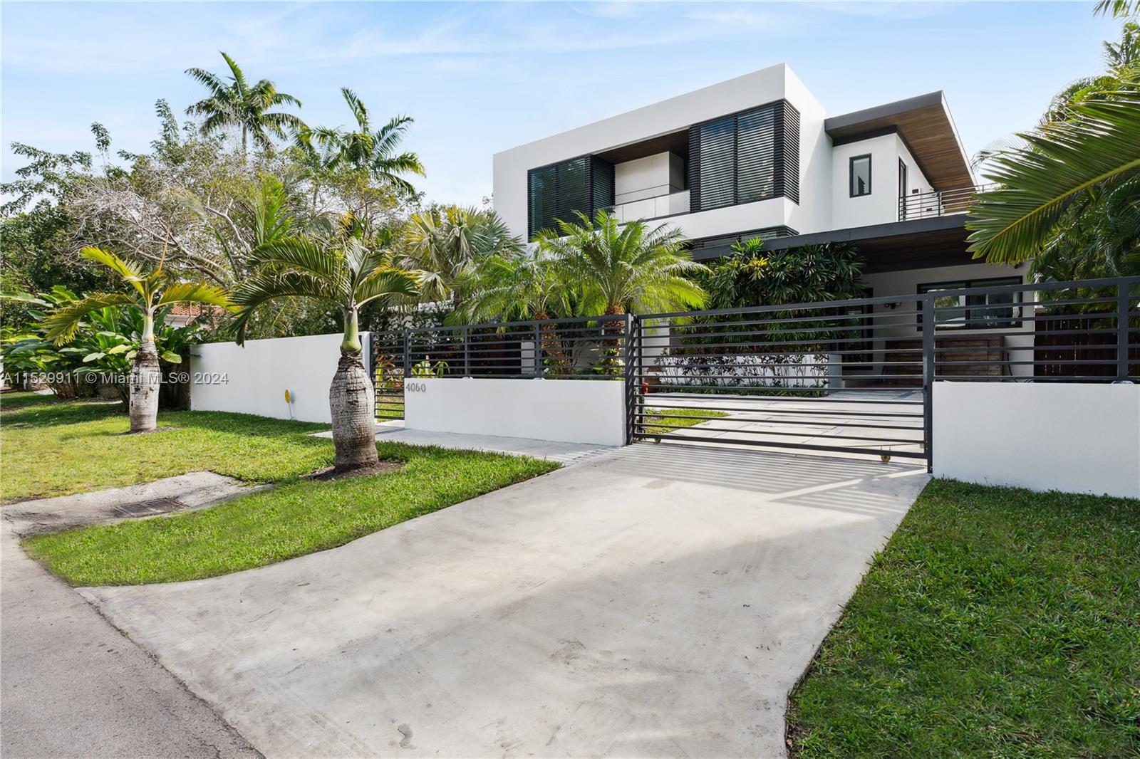 4060 Woodridge Road Miami, FL 33133 - Photo 37 of 49 a view of a house with a yard and large tree