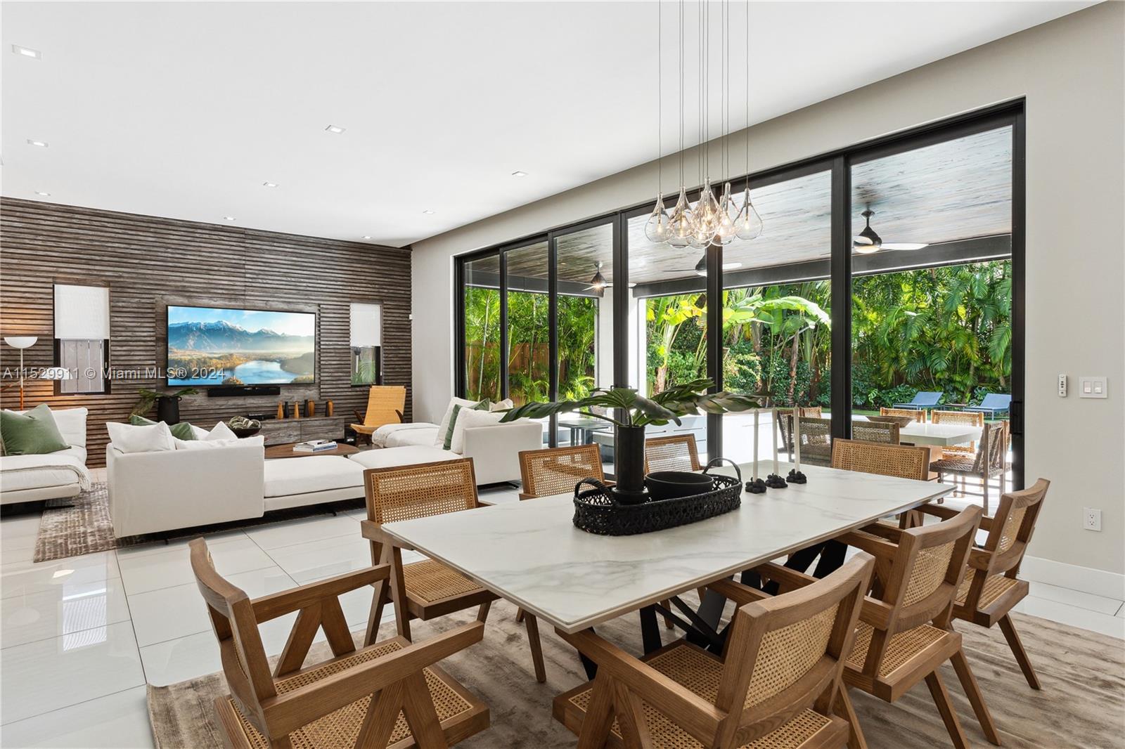 4060 Woodridge Road Miami, FL 33133 - Photo 4 of 49 a living room with furniture and a flat screen tv