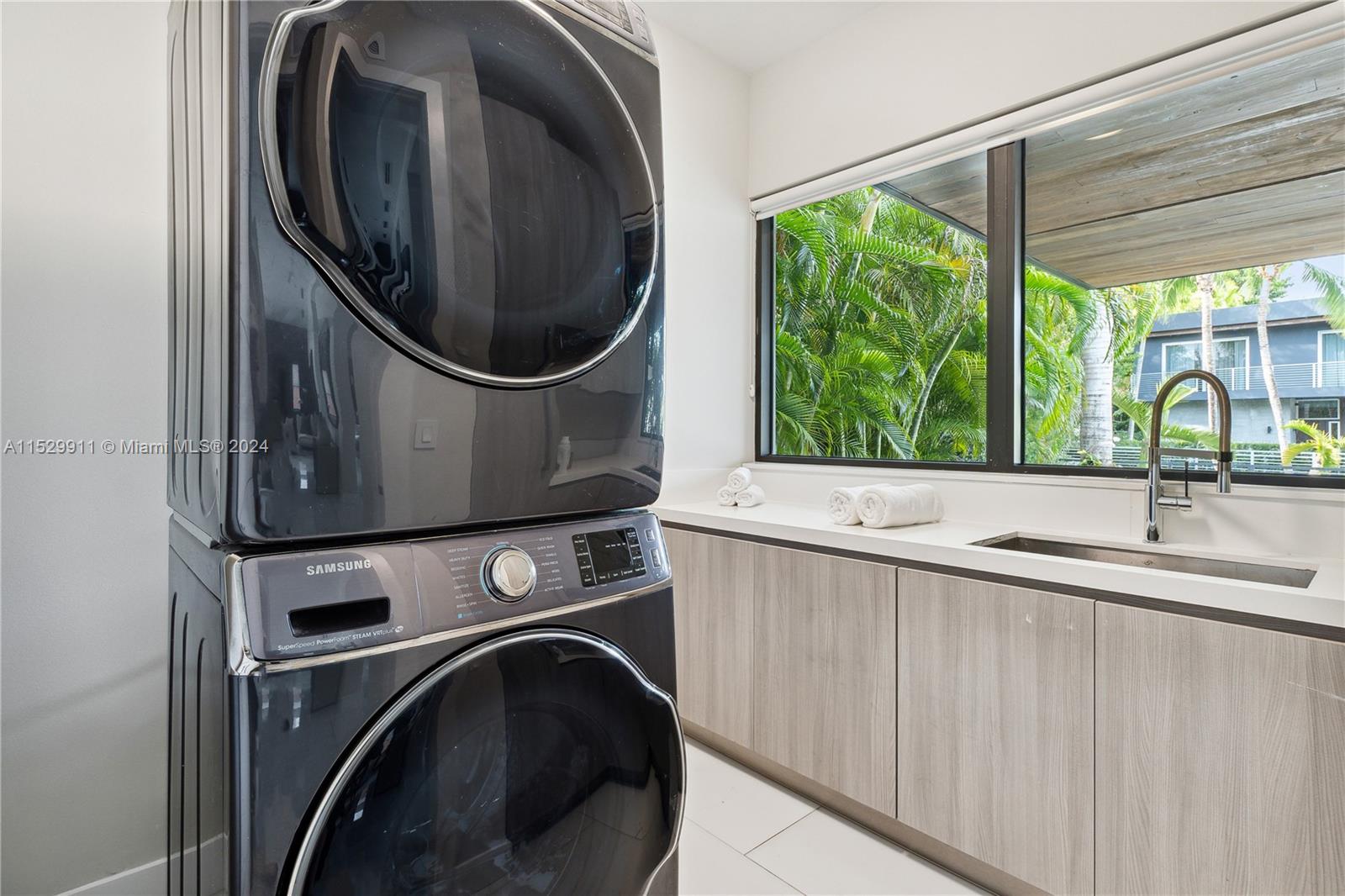 4060 Woodridge Road Miami, FL 33133 - Photo 42 of 49 a utility room with sink dryer and washer
