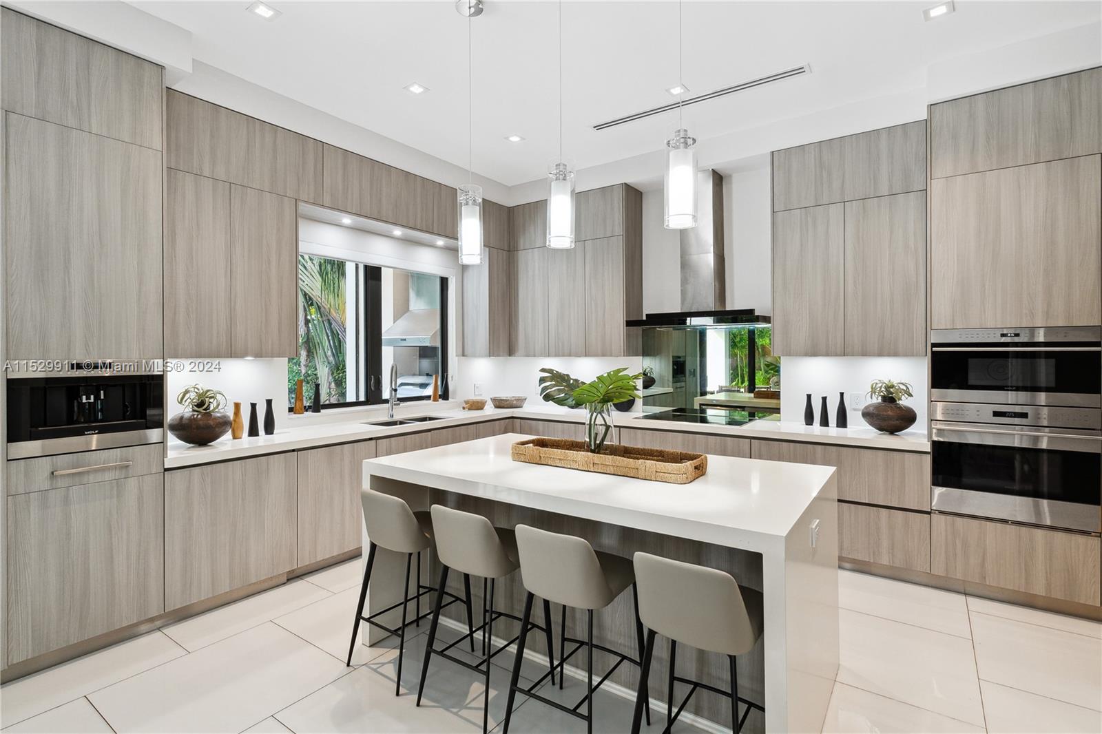 4060 Woodridge Road Miami, FL 33133 - Photo 8 of 49 a kitchen with stainless steel appliances kitchen island granite countertop a sink and cabinets