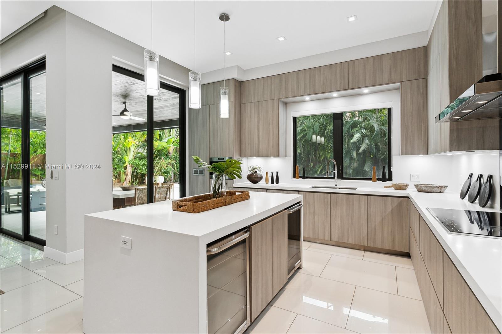4060 Woodridge Road Miami, FL 33133 - Photo 10 of 49 a kitchen with a sink stove and cabinets