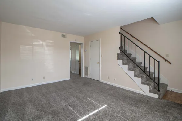 a view of an empty room with stairs