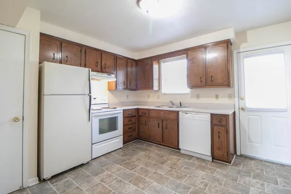 a kitchen with a refrigerator sink and cabinets