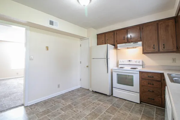 a kitchen with a stove and a refrigerator