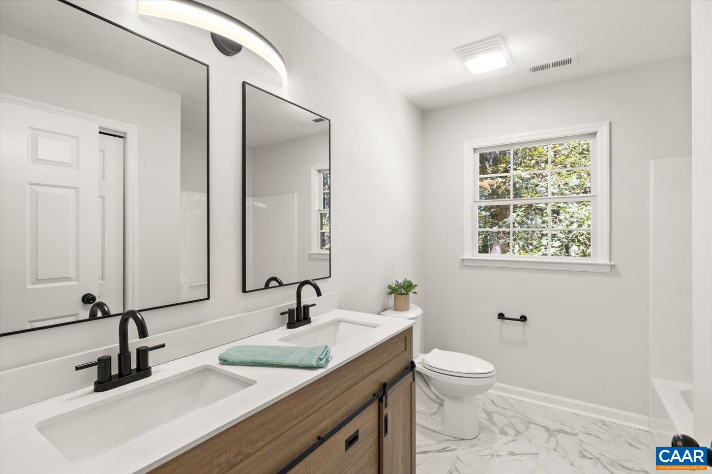 15379 Louisa Road Louisa, VA 23093 - Photo 24 of 45 a bathroom with a granite countertop sink a toilet and a mirror