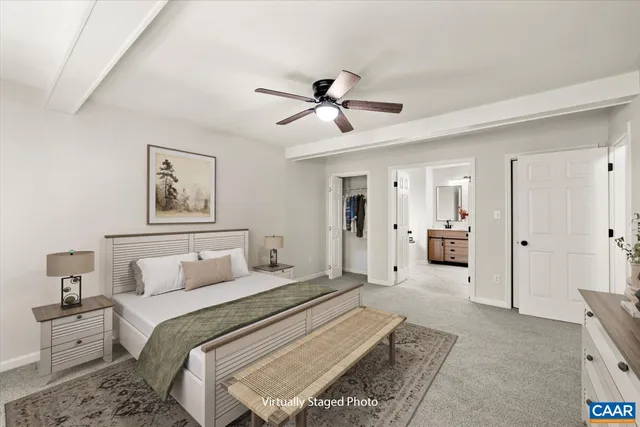 a spacious bedroom with a bed and ceiling fan