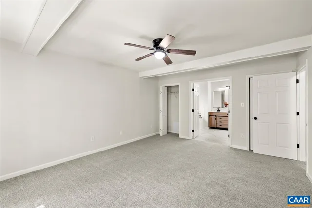 a view of a livingroom with a ceiling fan and window
