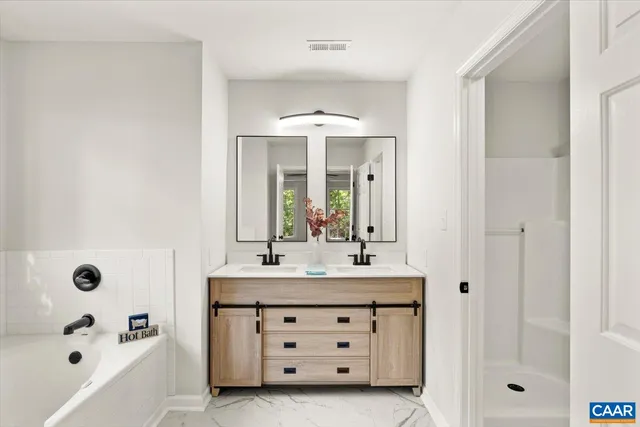 a bathroom with a sink bath tub and shower