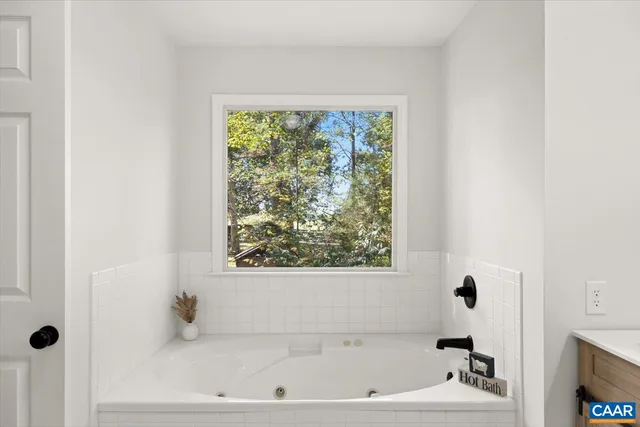 a bathroom with a bathtub and a window