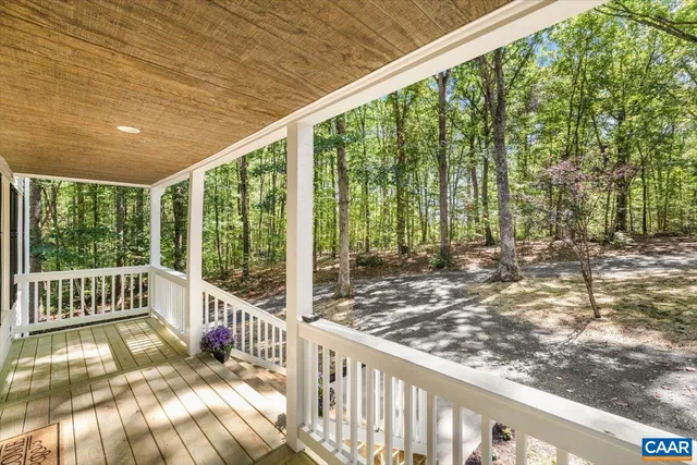 a view of a porch with wooden floor and fence