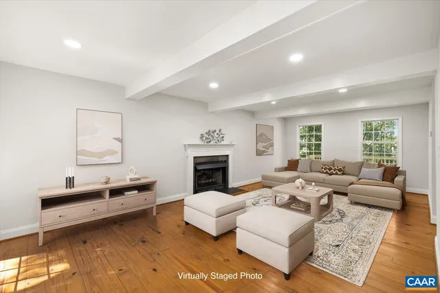 a living room with furniture fireplace and rug