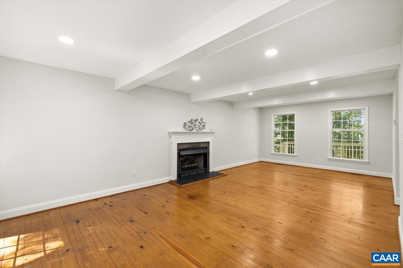 15379 Louisa Road Louisa, VA 23093 - Photo 9 of 45 a view of empty room with wooden floor and fireplace