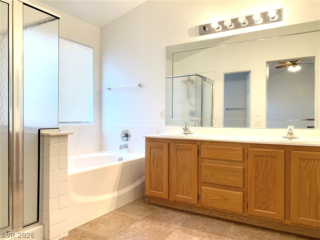 3821 Bombastic Court Las Vegas, NV 89147 - Photo 26 of 36 This spacious bathroom offers a double vanity and a comfortable soaking tub.
