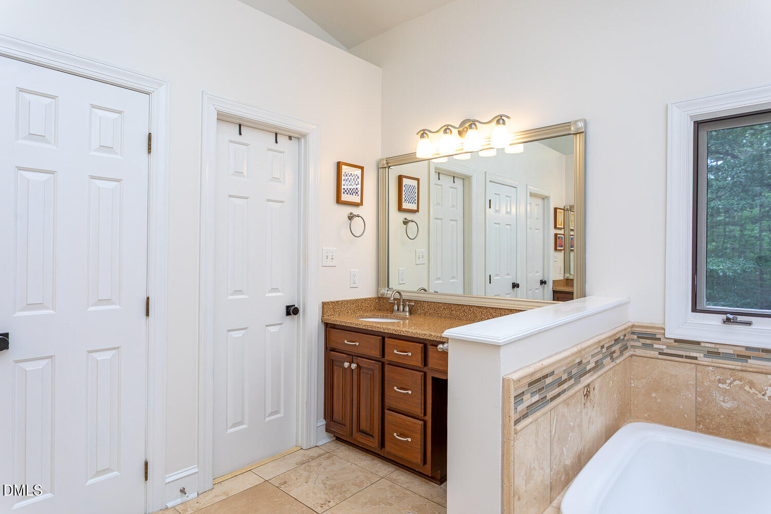 8509 Towneley Place Raleigh, NC 27615 - Photo 18 of 36 a spacious bathroom with a granite countertop sink and a mirror