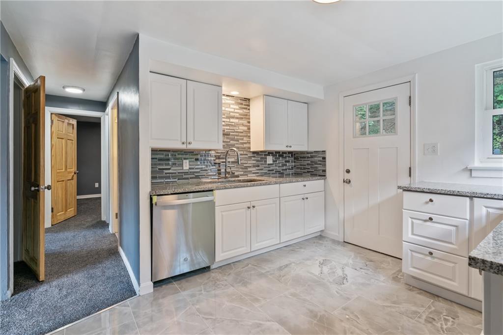 629 Beulah Road Pittsburgh, PA 15235 - Photo 5 of 26 a kitchen with granite countertop white cabinets and white appliances
