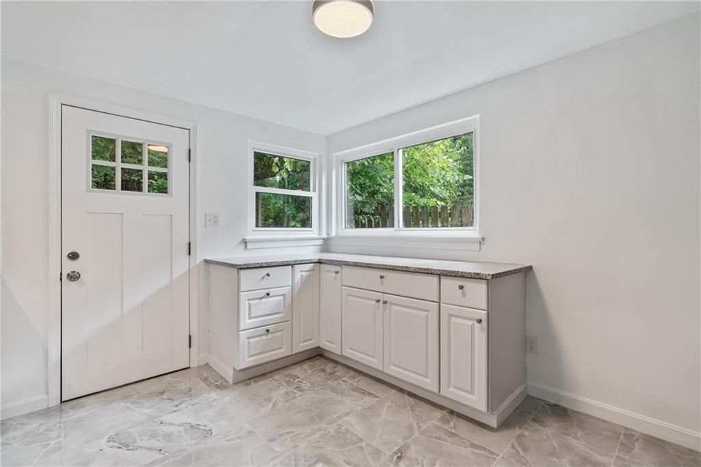 629 Beulah Road Pittsburgh, PA 15235 - Photo 8 of 26 a kitchen with white cabinets and a window