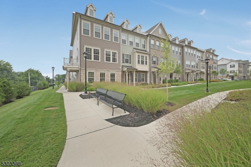 32 Gala Court Livingston, NJ 07039 - Photo 16 of 17 a view of a big building with a big yard and potted plants