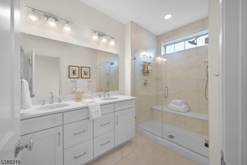 32 Gala Court Livingston, NJ 07039 - Photo 7 of 17 a bathroom with a double vanity sink mirror double and shower