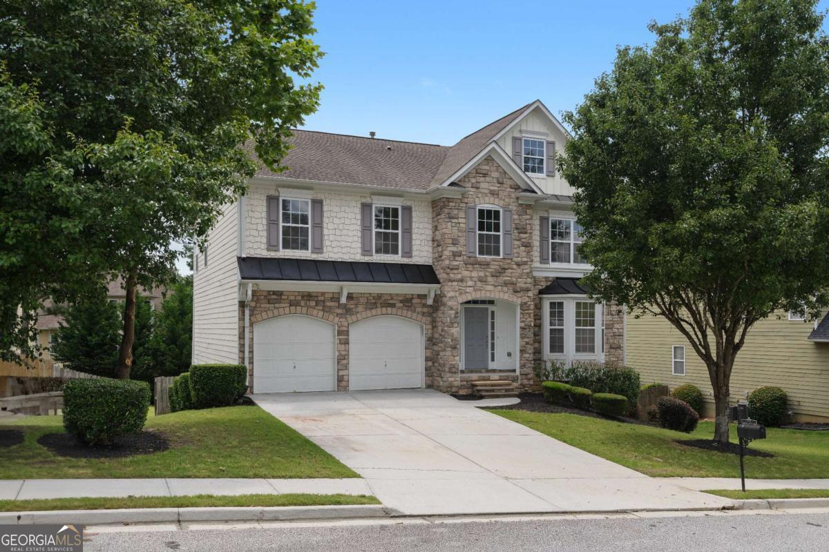 a front view of a house with a yard and garage