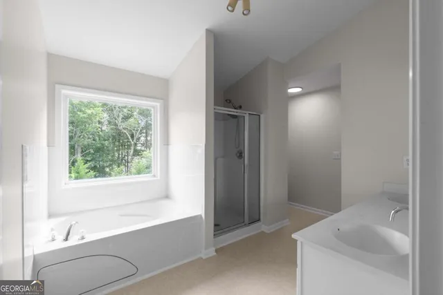 a bathroom with a tub sink and window