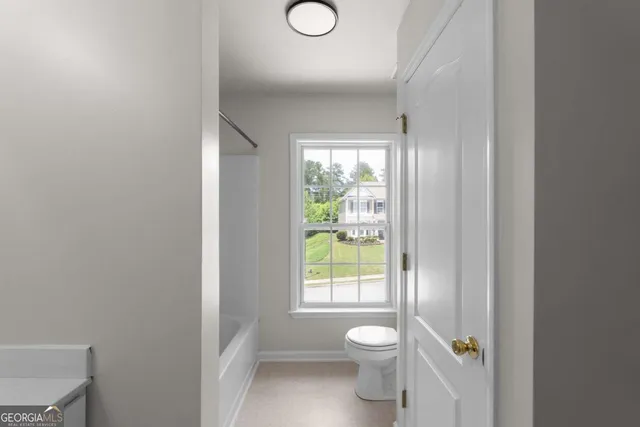 a bathroom with a toilet sink and window