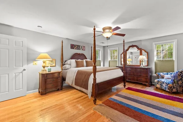a bedroom with bed and wooden floor