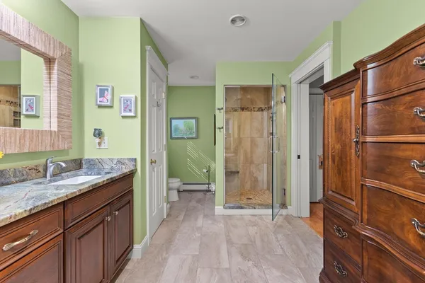 a spacious bathroom with a shower sink and mirror