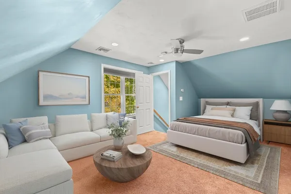 a bedroom with a bed couch and window