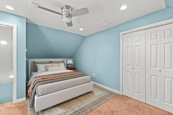 a bedroom with a bed and a ceiling fan