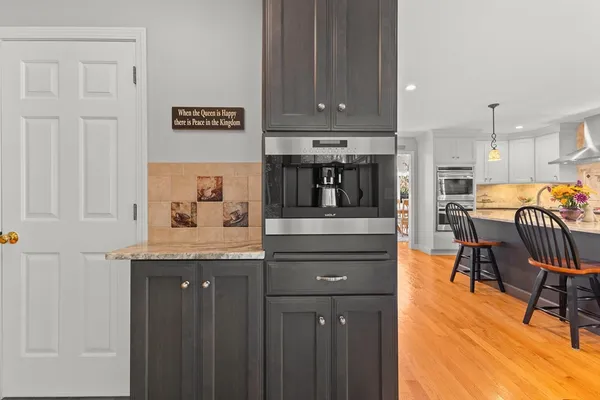 a view of dining table chairs and cabinets