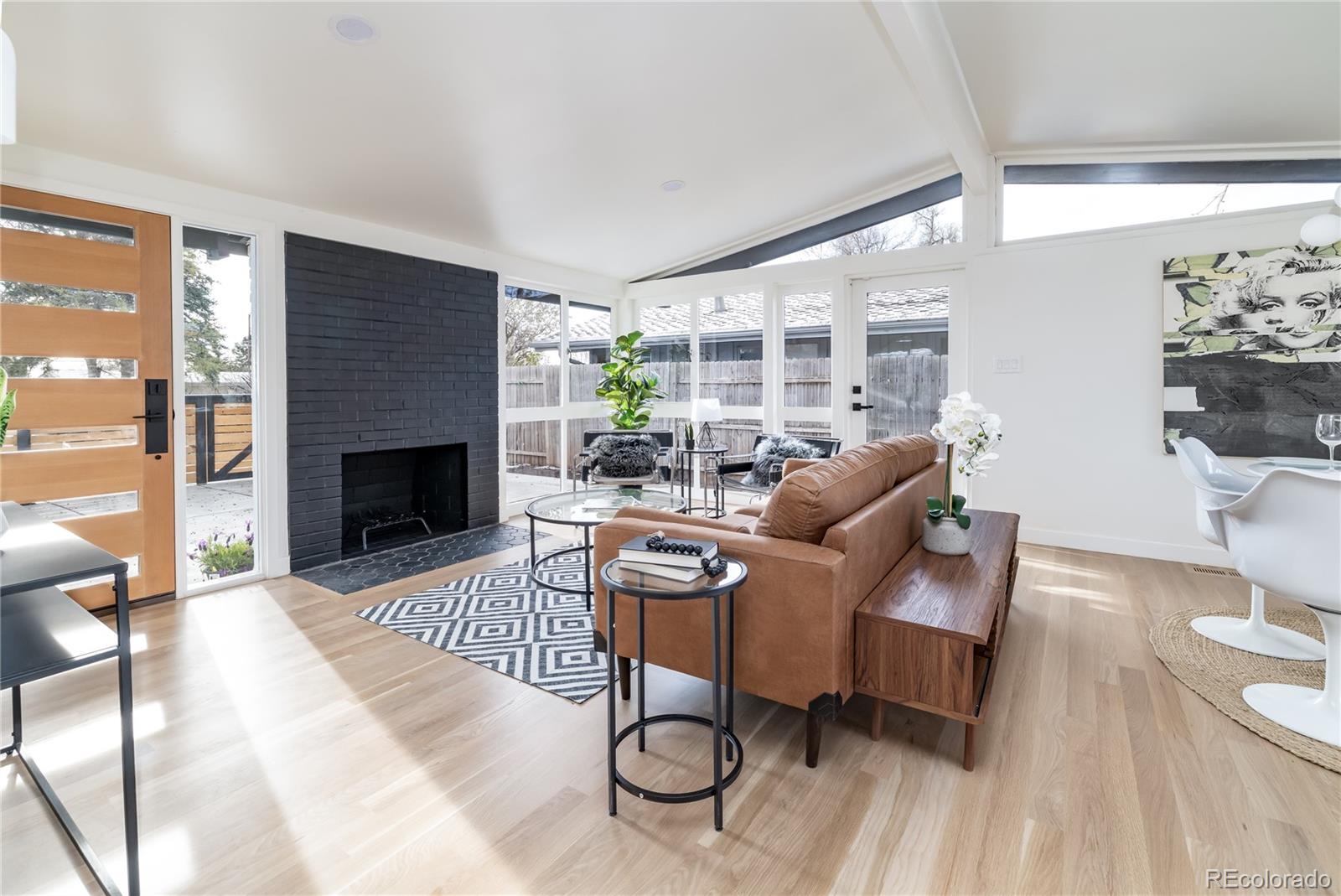 a living room with furniture a rug and a fireplace