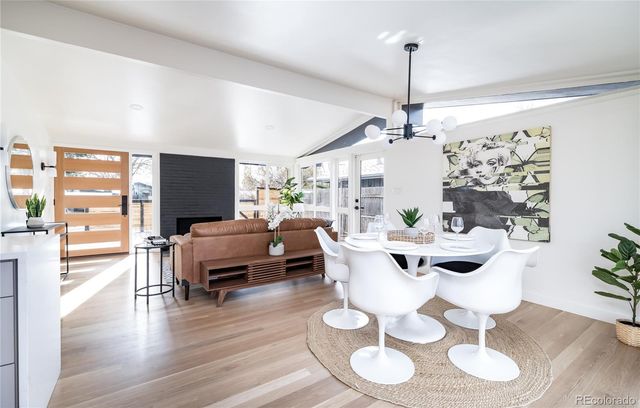 a living room with furniture a flat screen tv and a large window