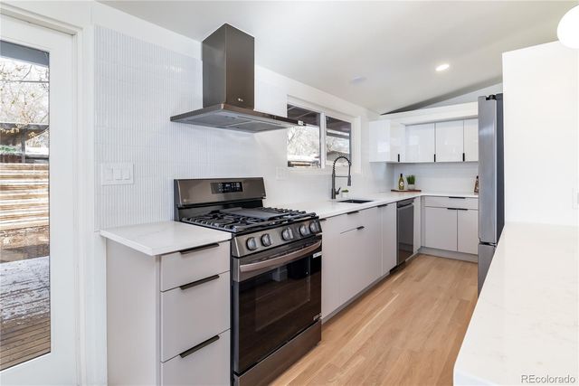 a kitchen with a stove top oven and sink