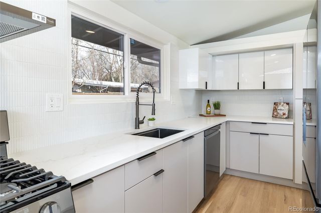 a kitchen with a sink stove and cabinets
